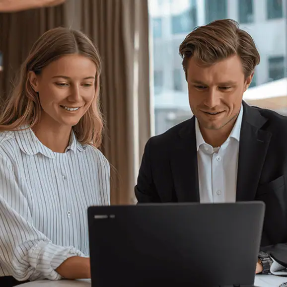 Medarbetare och chef som går igenom frågor för deras medarbetarsamtal, i ett modernt kontor